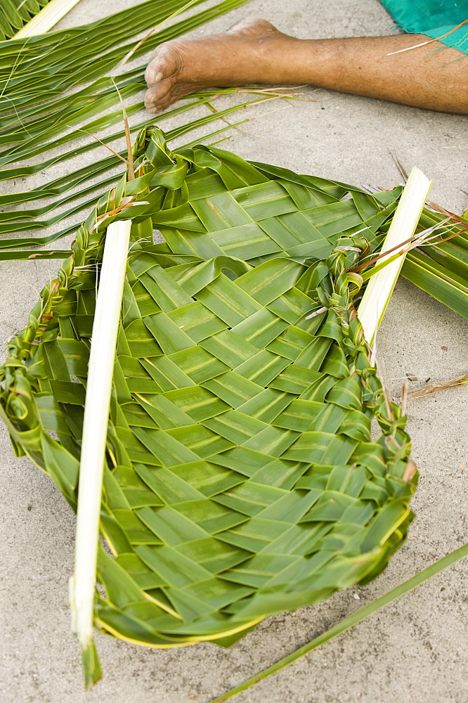 Weaving plates for a traditional Tuvaluan funeral feast on Funafuti Atoll, Tuvalu, Pacific