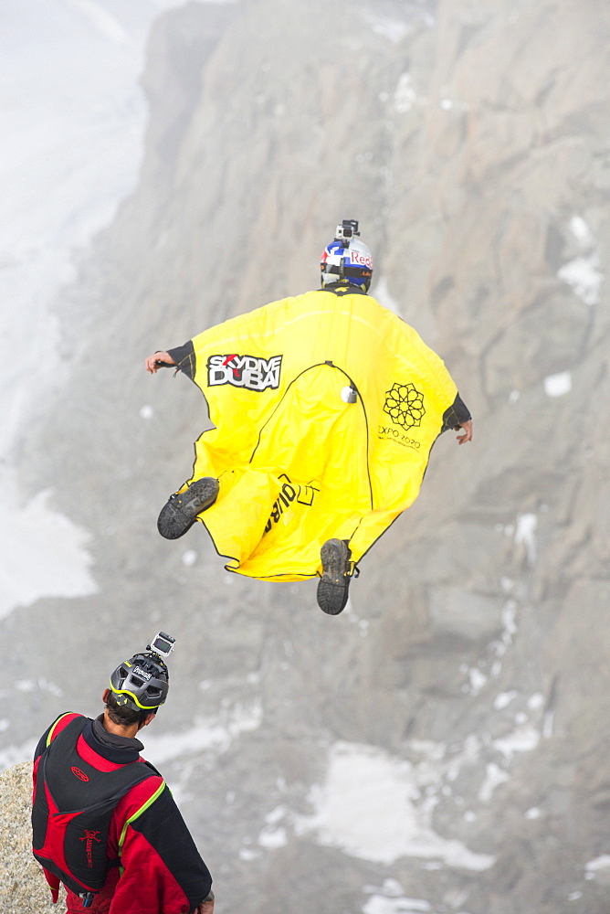 Base jumpers wearing wing suites jump from the Aiguille Du midi above Chamonix, France.