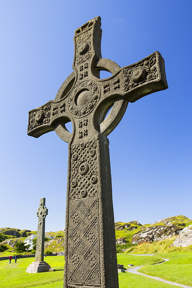 St john's Cross in the grounds of Iona Abbey, Iona, off mull, Scotland, UK, with St Oran's Cross in the background