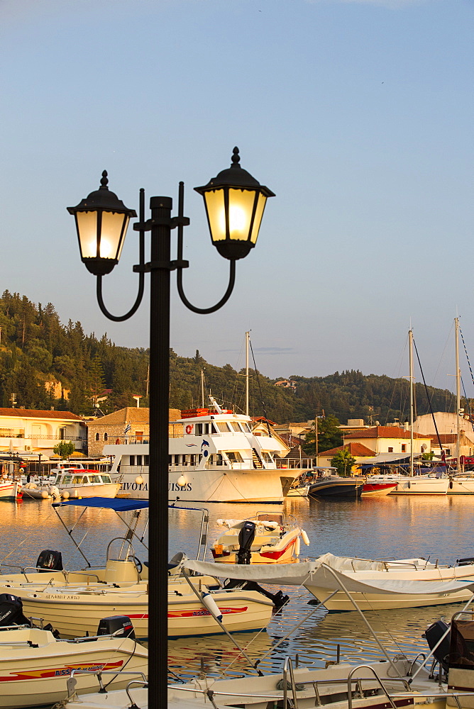 Boats in the harbour at Sivota, Greece, at sunset.