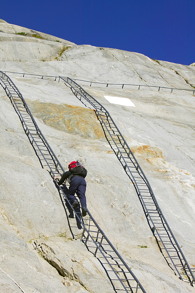 Climbing ladders to reach the rapidly retreating Mer du Glace glacier, Chamonix, Haute Savoie, France, Europe