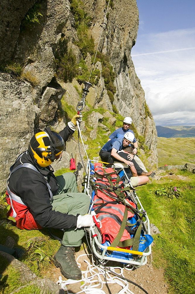 An injured climber with a dislocated shoulder is winched off Jacks Rake, Pavey Ark by the Langdale Ambleside Mountain Rescue Team, Lake District, Cumbria, England, United Kingdom, Europe