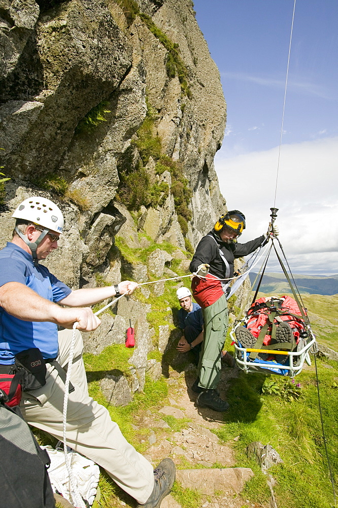 An injured climber with a dislocated shoulder is winched off Jacks Rake Pavey Ark by the Langdale Ambleside Mountain Rescue Team, Lake District, Cumbria, England, United Kingdom, Europe