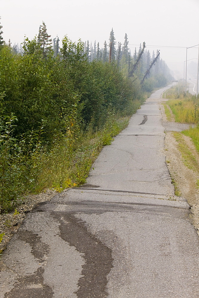 Pavement in Fairbanks collapsing into the ground due to global warming induced permafrost melt, Alaska, United States of America, North America