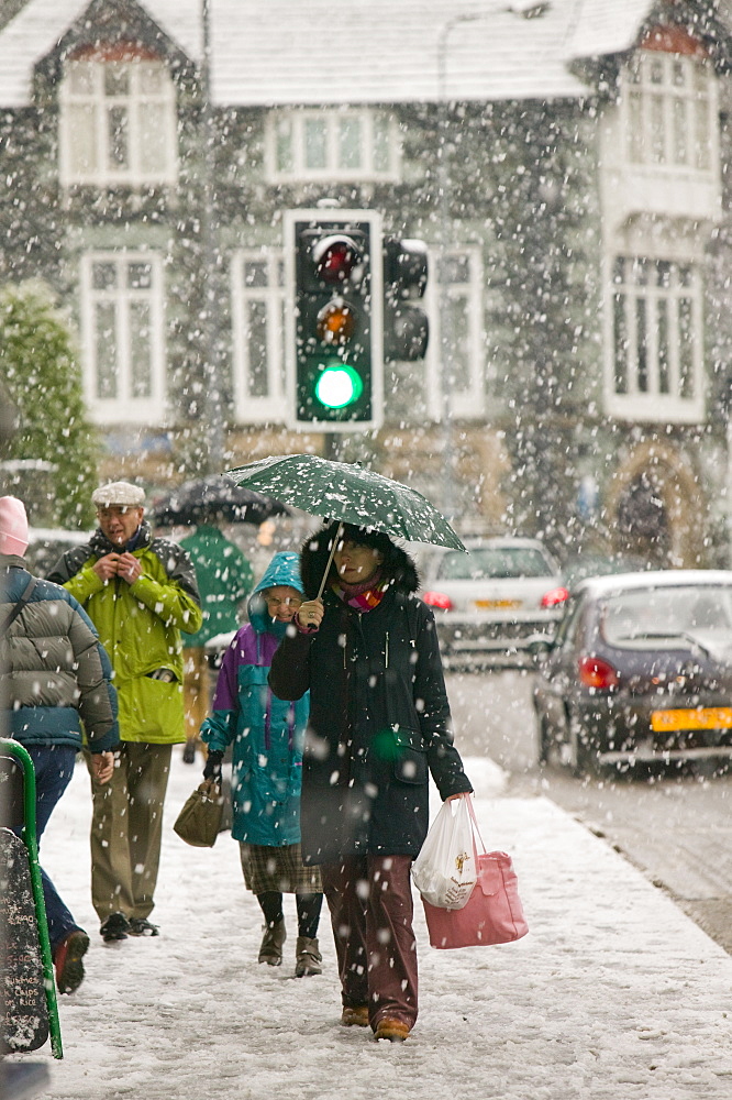 Shoppers trudging through snow in Ambleside, Cumbria, England, United Kingdom, Europe