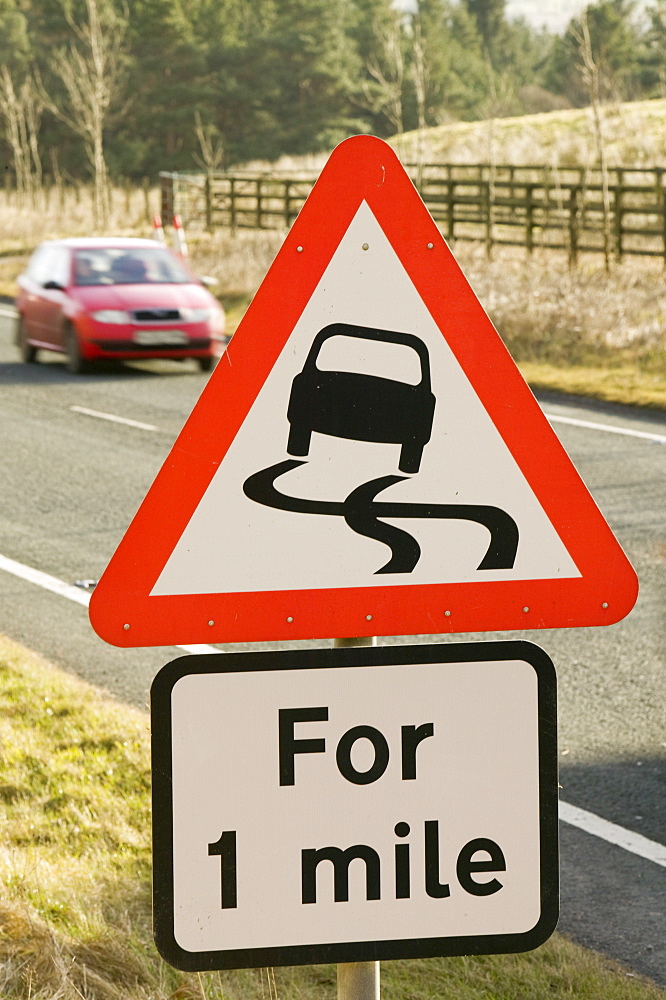 A road warning sign of slippery conditions, England, United Kingdom, Europe