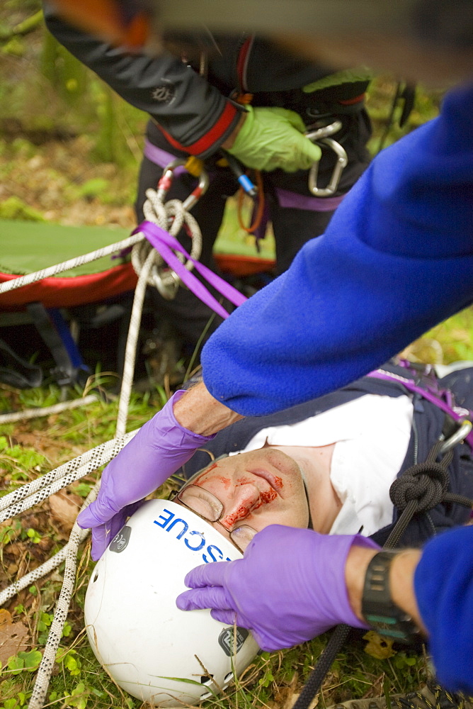 Members of the Langdale Ambleside Mountain Rescue Team treat an injured walker in the Lake District, Cumbria, England, United Kingdom, Europe