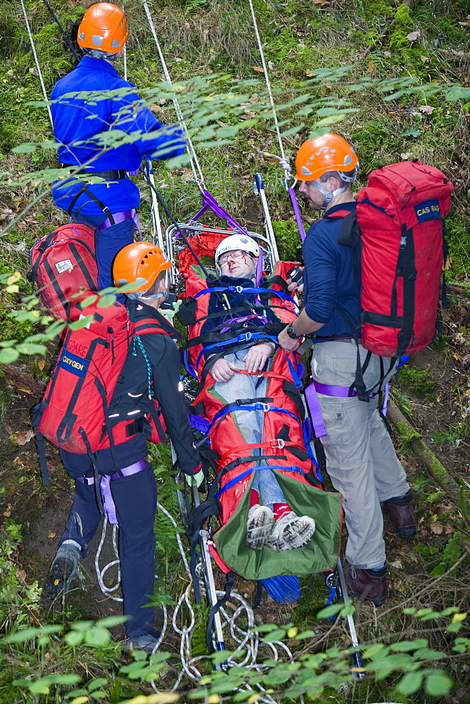 Members of the Langdale Ambleside Mountain Rescue Team treat an injured walker in the Lake District, Cumbria, England, United Kingdom, Europe