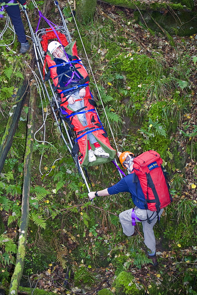 Members of the Langdale Ambleside Mountain Rescue Team treat an injured walker in the Lake District, Cumbria, England, United Kingdom, Europe