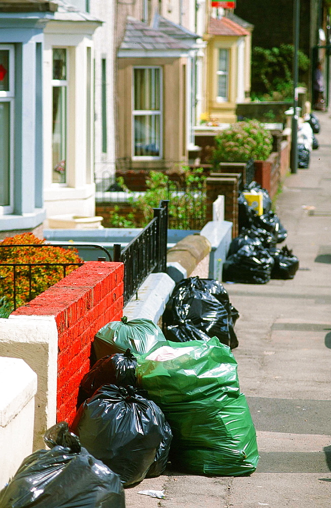 Rubbish on the street awaiting collection, England, United Kingdom, Europe