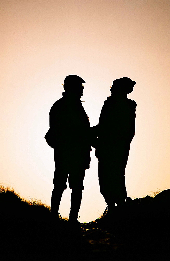 An old couple walking in the countryside