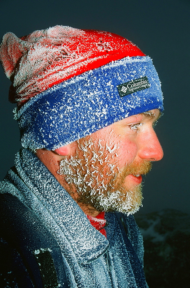 A mountaineer covered in hoar frost on Helvellyn, Cumbria, England, United Kingdom, Europe