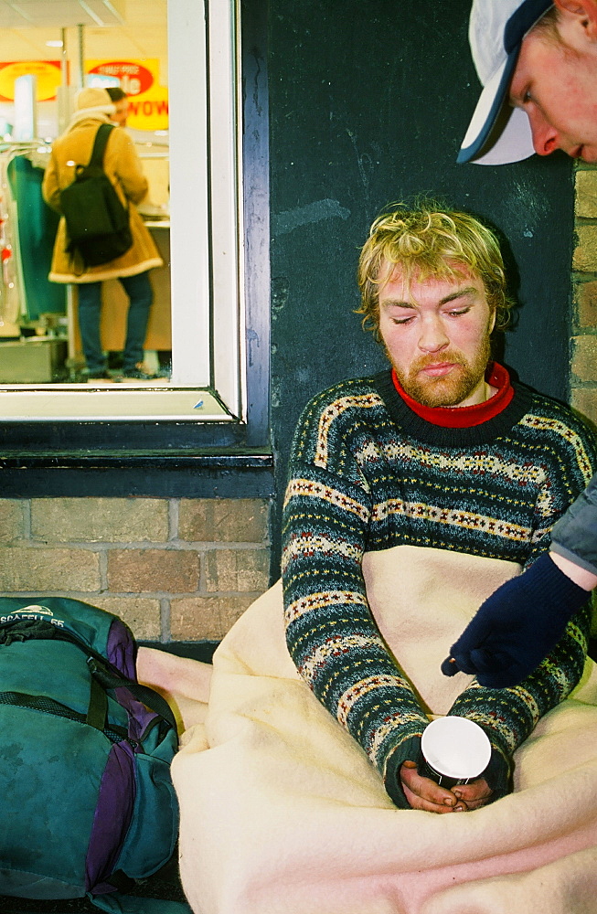 A homeless man sleeping rough and begging on the streets of Leeds, Yorkshire, England, United Kingdom, Europe