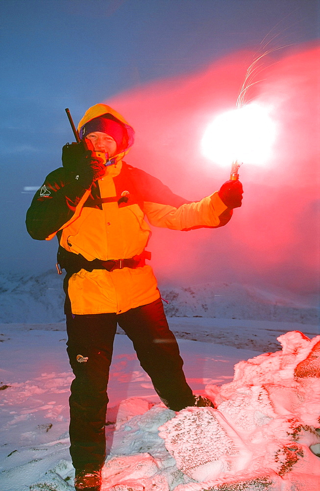 A member of Langdale Ambleside mountain Rescue Team with a flare on the radio, Lake District, Cumbria, England, United Kingdom, Europe