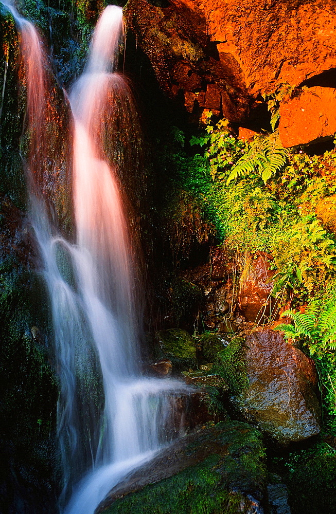 Sunset light on a waterfall above Thirlmere in the Lake District National Park, Cumbria, England, United Kingdom, Europe