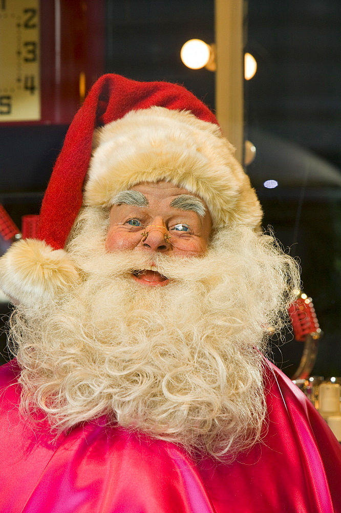 Father Christmas in a window display in a department store on Oxford Street in London, England, United Kingdom, Europe