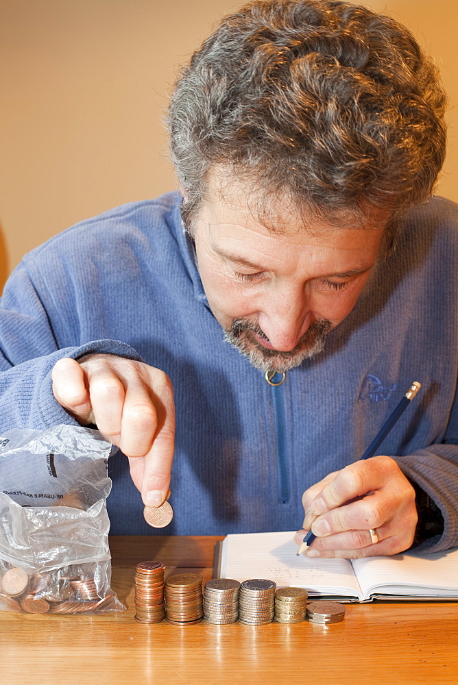 A miserly man counting his money