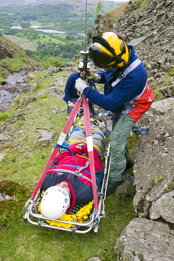 An RAF Sea King Helicopter winchman and casualty on a stretcher, Loughrigg in the Lake District, Cumbria, England, United Kingdom, Europe