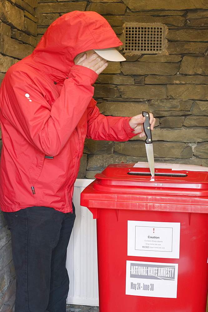 A knife amnesty with a criminal handing over a knife at a police station, Cumbria, England, United Kingdom, Europe