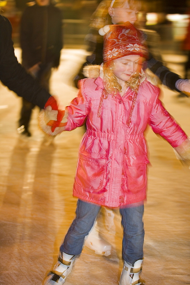 A young girl skating on an artificial ice rink in Lincoln city centre, Lincoln, Lincolnshire, England, United Kingdom, Europe