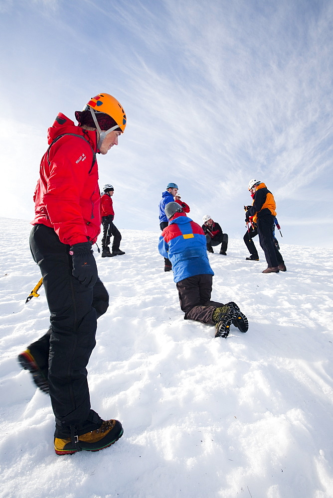 A group of mountaineers practise ice axe arrests on Cairngorm in the Cairngorm National Park in Scotland, United Kingdom, Europe