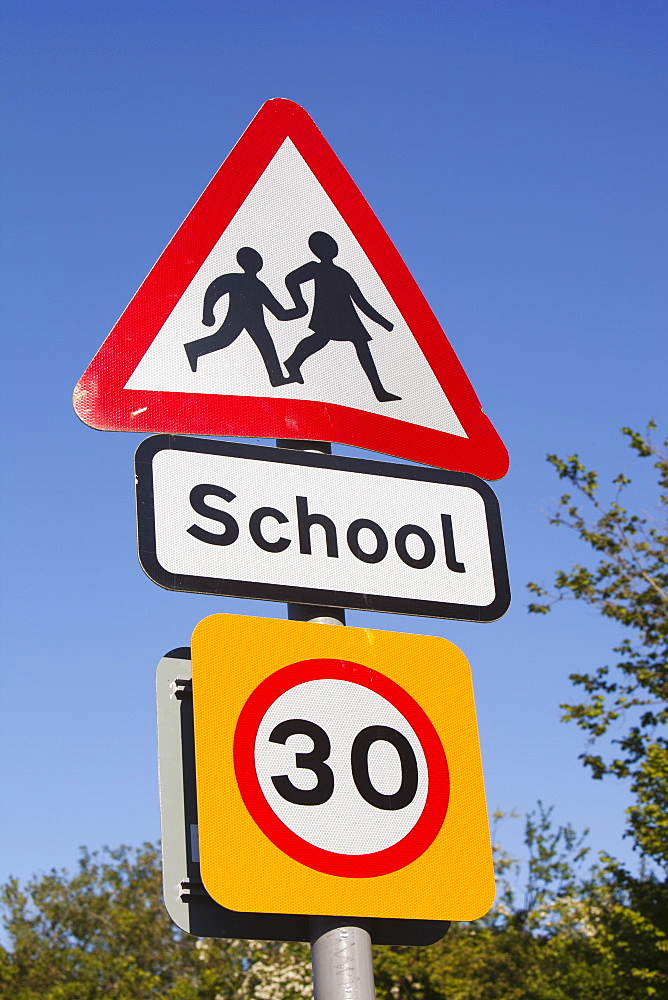 A school sign and speed limit sign in Berrynarbor, Devon, England, United Kingdom, Europe