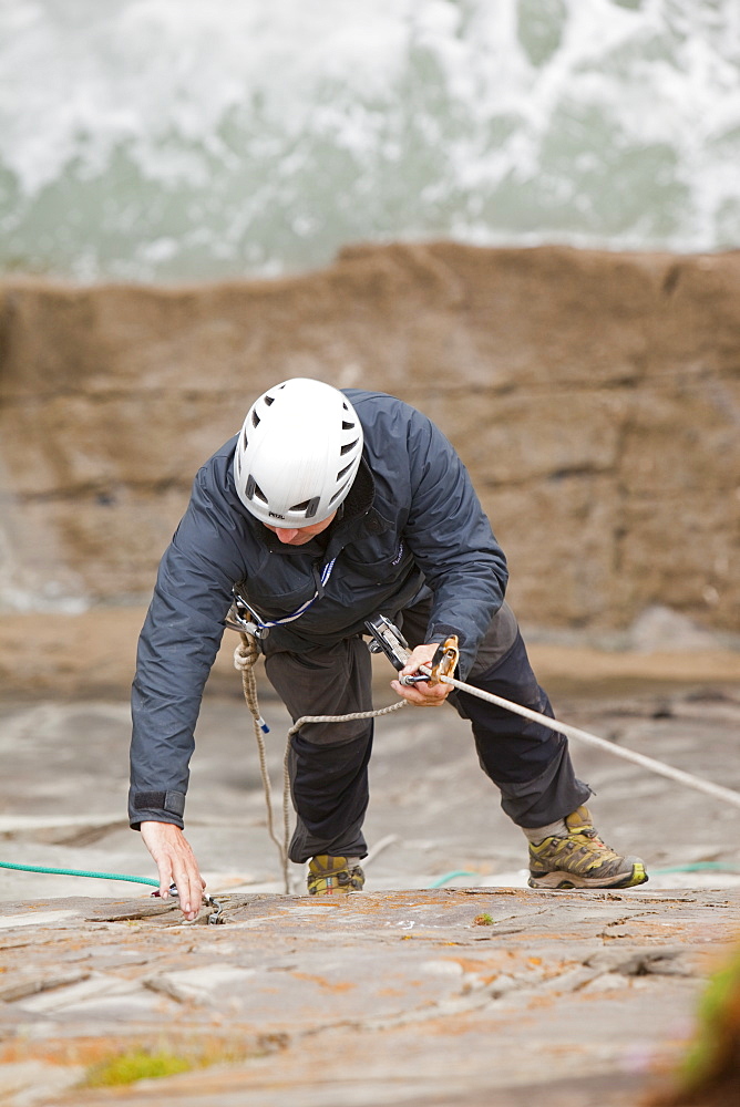 Climber on a sea cliff climb on Baggy Point near Croyde in north Devon, England, United Kingdom, Europe