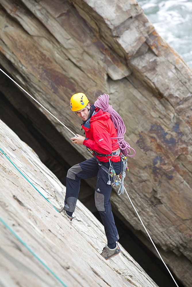 Climber on a sea cliff climb on Baggy Point near Croyde in north Devon, England, United Kingdom, Europe