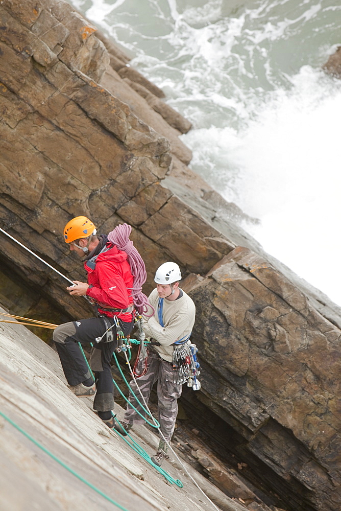 Climber on a sea cliff climb on Baggy Point near Croyde in north Devon, England, United Kingdom, Europe