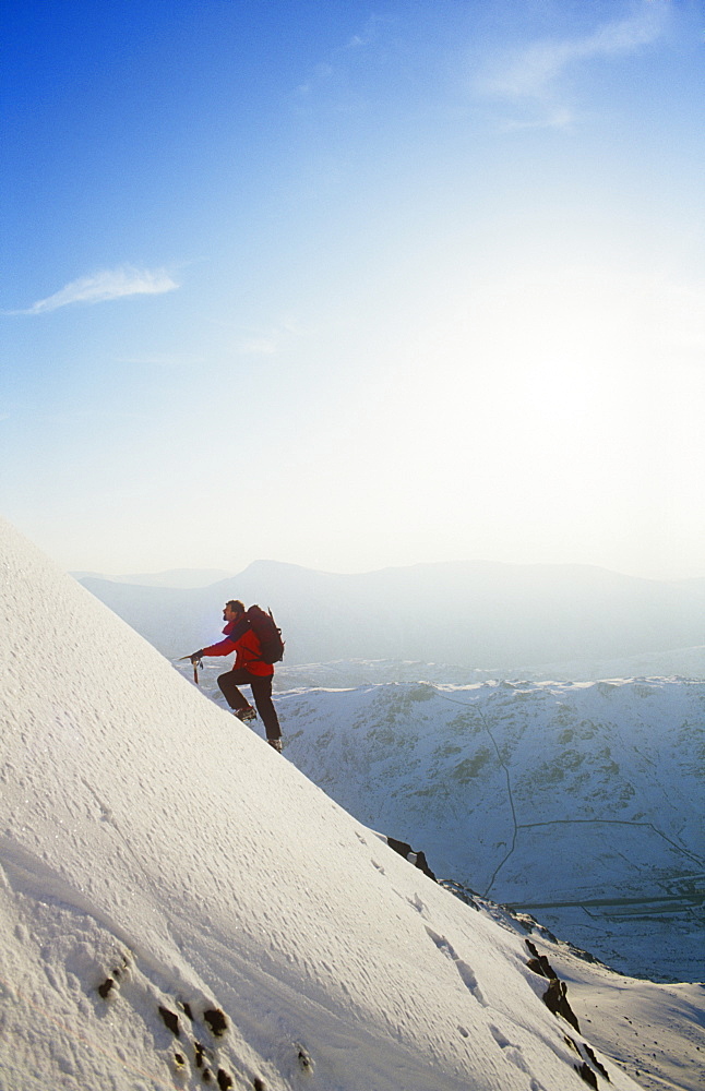 A mountaineer winter climbing on Red Screes in the Lake District, Cumbria, England, United Kingdom, Europe