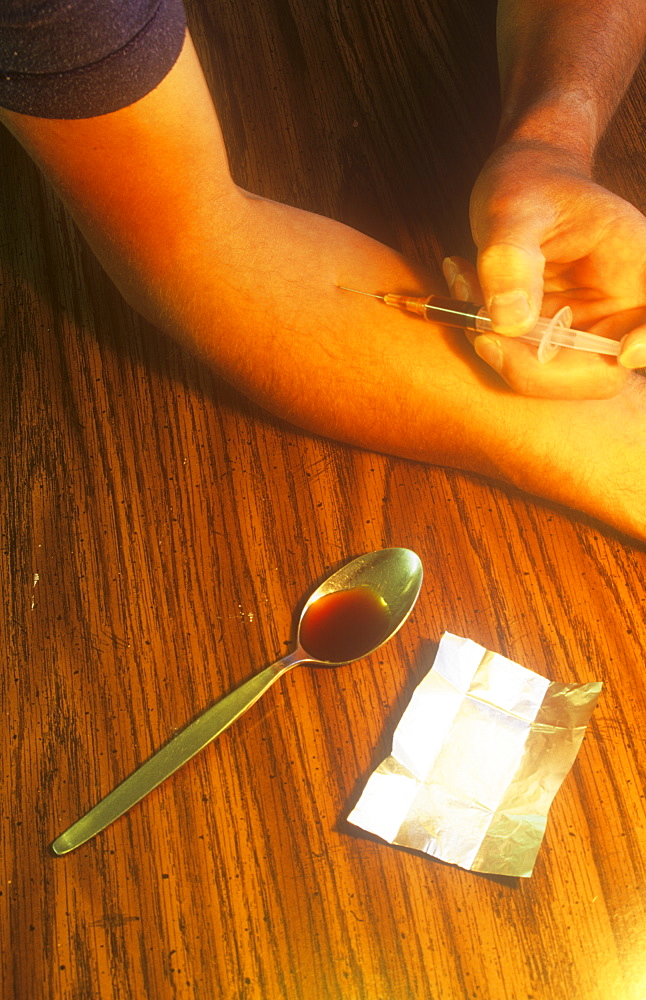 Mockup of a heroin addict injecting the drug