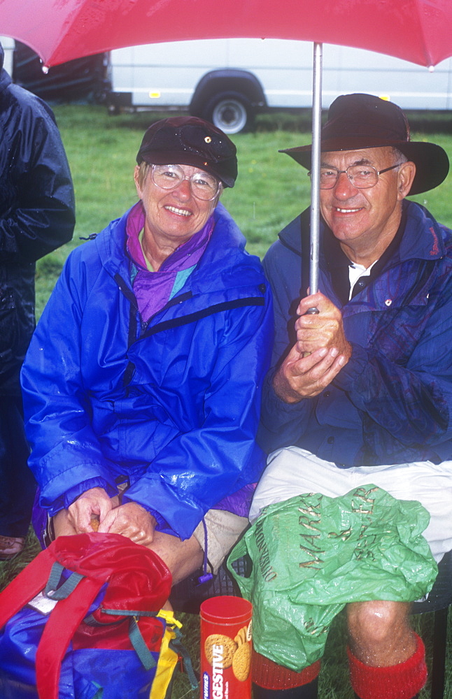 Spectators at the Ambleside Sports in the rain, Lake District, Cumbria, England, United Kingdom, Europe