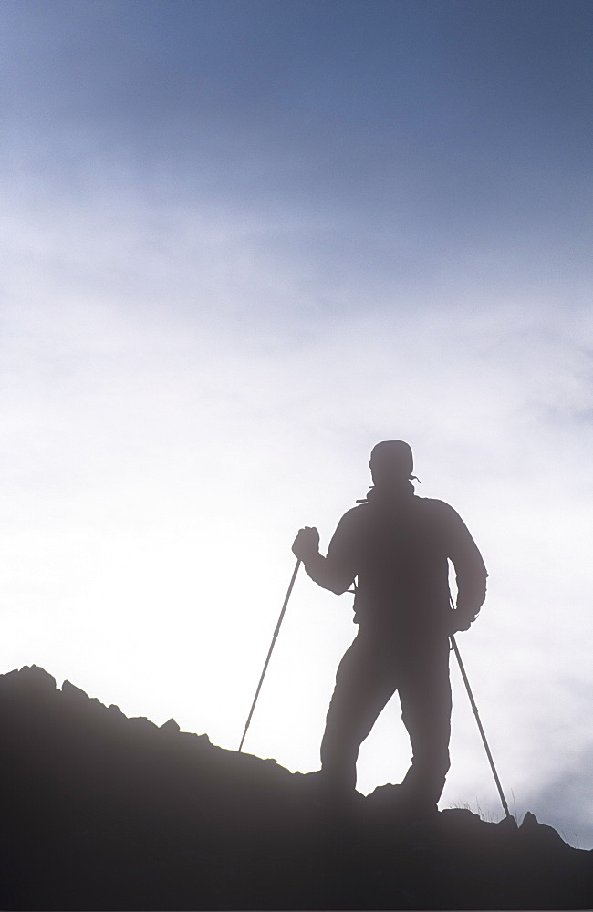 A mountaineer using walking poles in the Lake District, Cumbria, England, United Kingdom, 