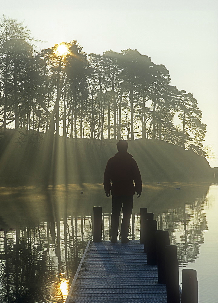 A man on a jetty on Lake Windermere, Lake District, Cumbria, England, United Kingdom, Europe