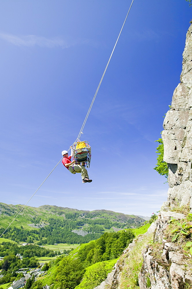 Members of Langdale Ambleside Mountain Rescue Team doing a stretcher lower down a crag in Langdale as part of training, Cumbria, England, United Kingdom, Europe