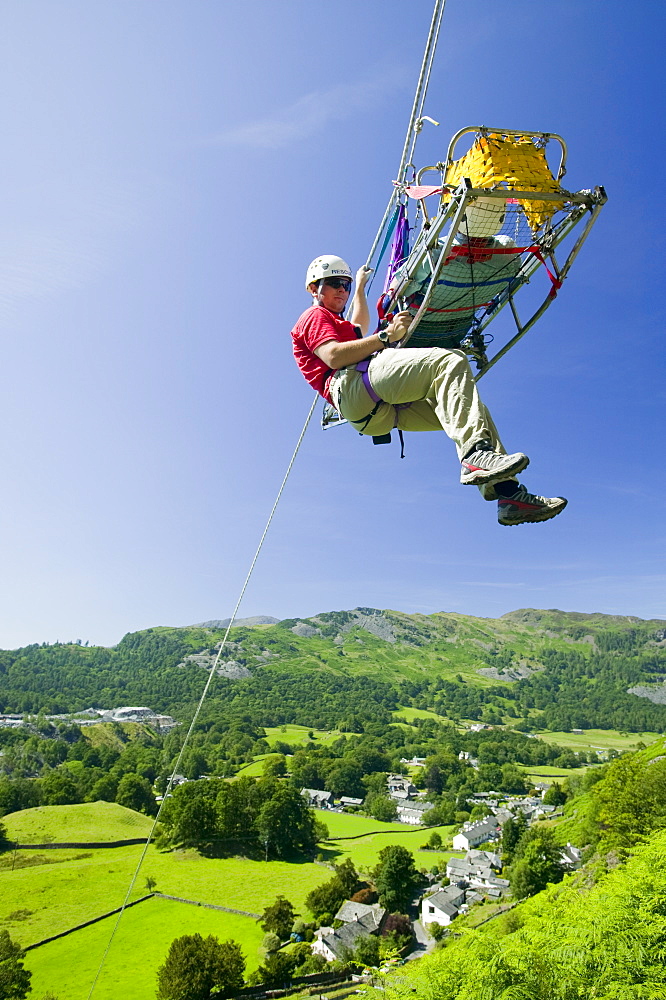 Members of Langdale Ambleside Mountain Rescue Team doing a stretcher lower down a crag in Langdale as part of training. Cumbria, England, United Kingdom, Europe