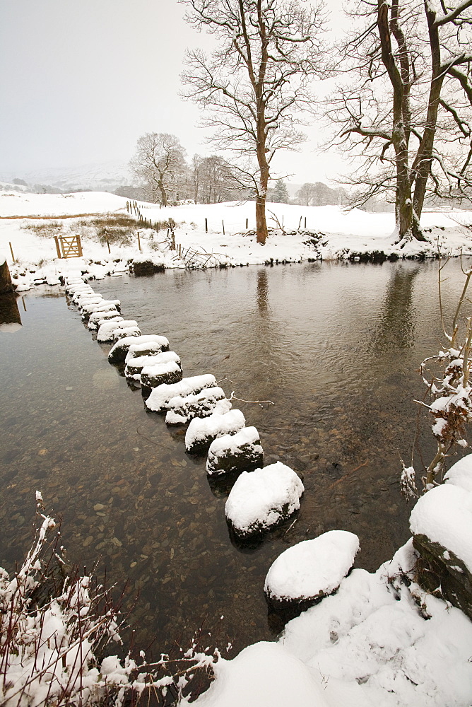 Snow on the stepping stones across the River Rothay in the Vale of Rydal in the Lake District, Cumbria, England, United Kingdom, Europe