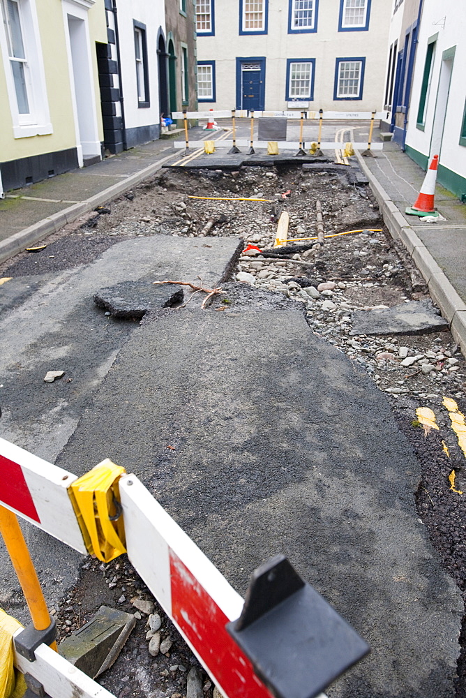 Gas main pipes revealed as the water ripped the tarmac off the road during the floods in November 2009, Cockermouth, Cumbria, England, United Kingdom, Europe