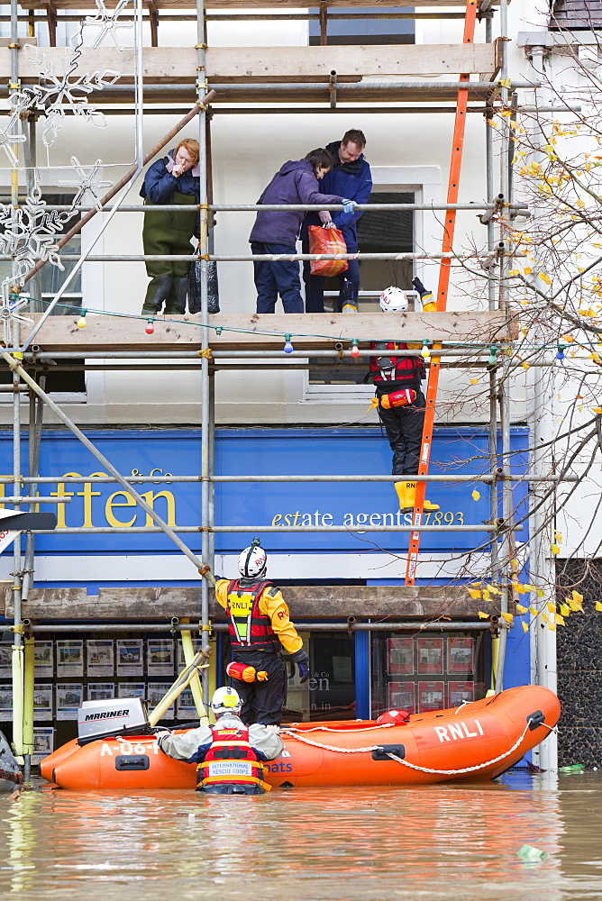 Rescue workers rescuing flood victims from their houses on the Main Street of Cockermouth, Cumbria, England, United Kingdom, Europe