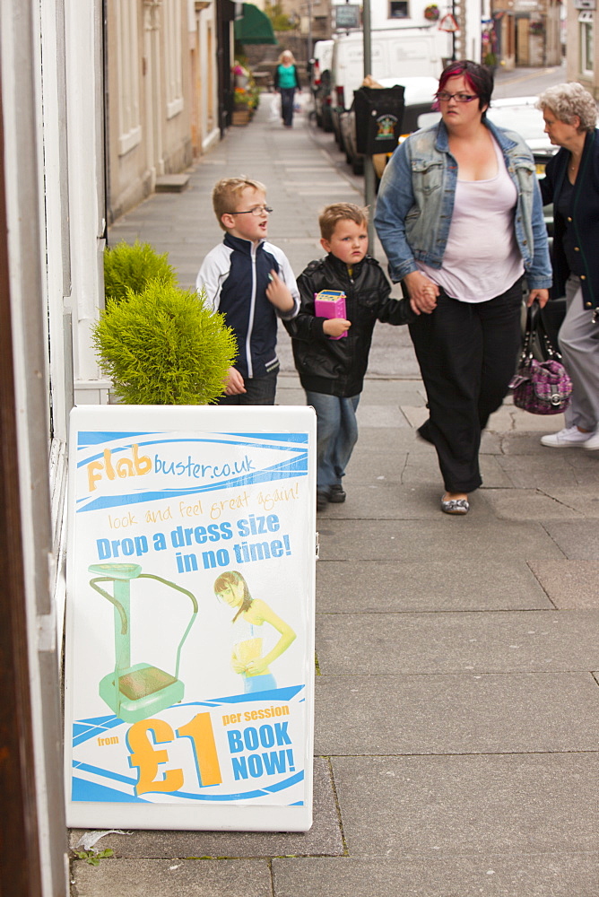 An advert for flab buster outside a shop in Clitheroe, Lancashire, England, United Kingdom, Europe