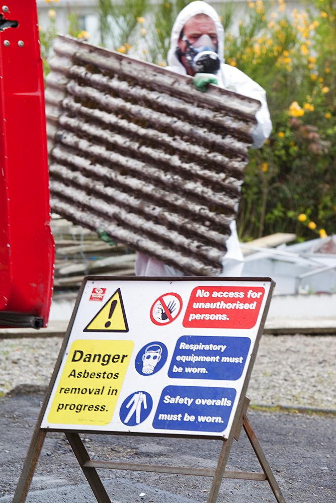 A specialist asbestos removal company removing asbestos from a shed roof in Ambleside, Cumbria England, United Kingdom, Europe