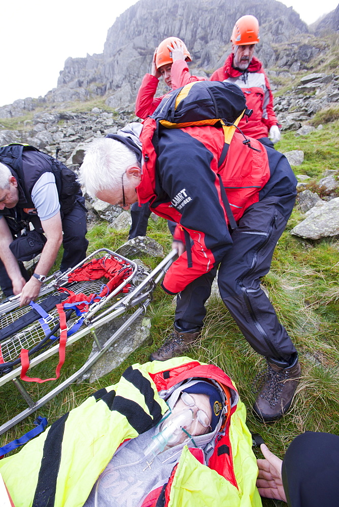 Members of the Langdale Ambleside Mountain Rescue Team, train in first aid using realistic actors from the Casualties Union, on Red Screes in the Lake District, Cumbria, England, United Kingdom, Europe