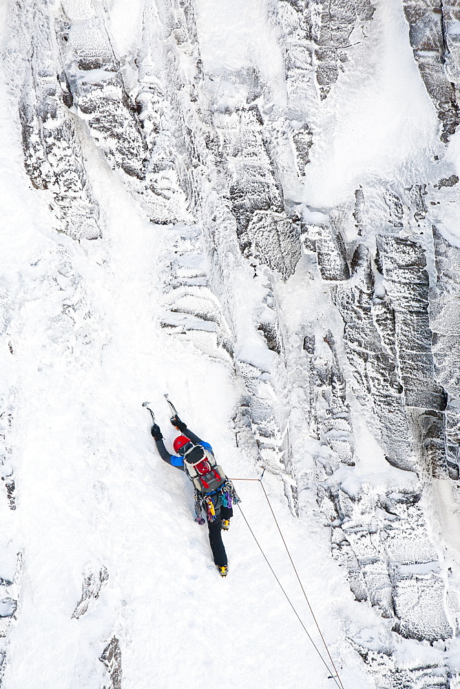 A mountaineer winter climbing in Coire an Sneachda in the Cairngorm mountains, Scotland, United Kingdom, Europe