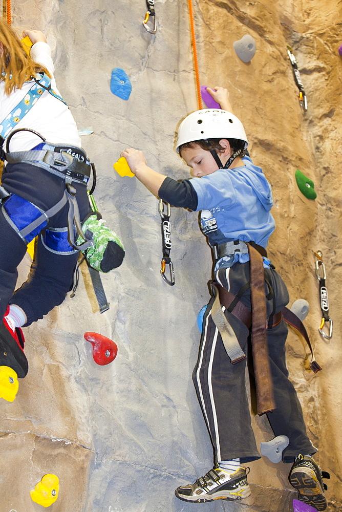 Young children on a climbing wall in Ambleside, Lake District, Cumbria, England, United Kingdom, Europe