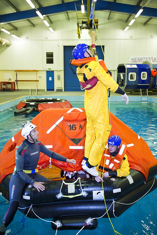 Workers in the offshore industry practise helicopter ditching evacuation as part of an industry training course, Billingham, Teesside, England, United Kingdom, Europe