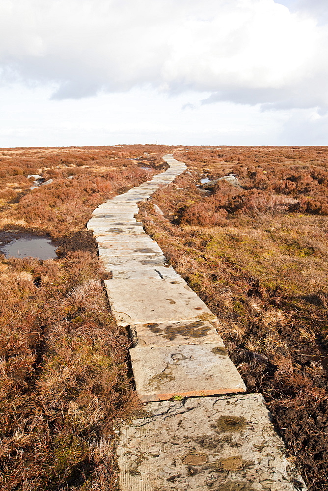 A stone flag path to combat erosion of the peat, towards the summit of Ilkley Moor, West Yorkshire, England, United Kingdom, Europe