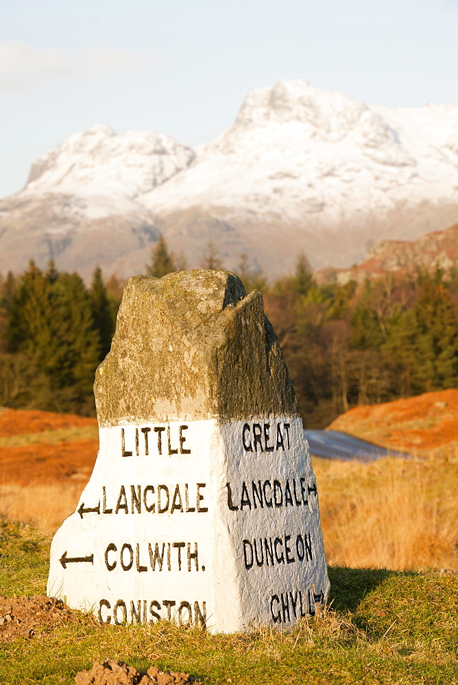 An old stone road sign in the Langdale valley at Elterwater looking towards the Langdale Pikes, Lake District National Park, Cumbria, England, United Kingdom, Europe