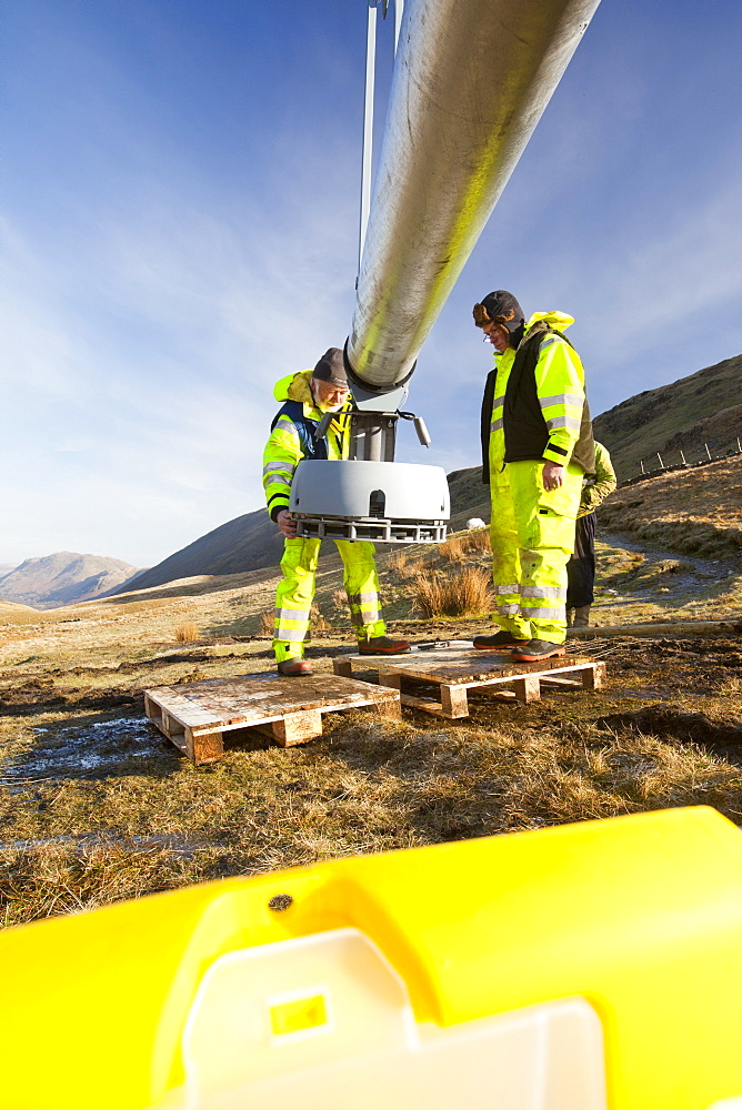 Three wind turbines being constructed behind the Kirkstone Pass Inn on Kirkstone Pass in the Lake District, Cumbria, England, United Kingdom, Europe