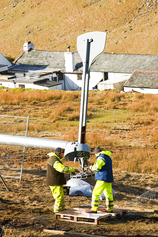 Three wind turbines being constructed behind the Kirkstone Pass Inn on Kirkstone Pass in the Lake District, Cumbria, England, United Kingdom, Europe