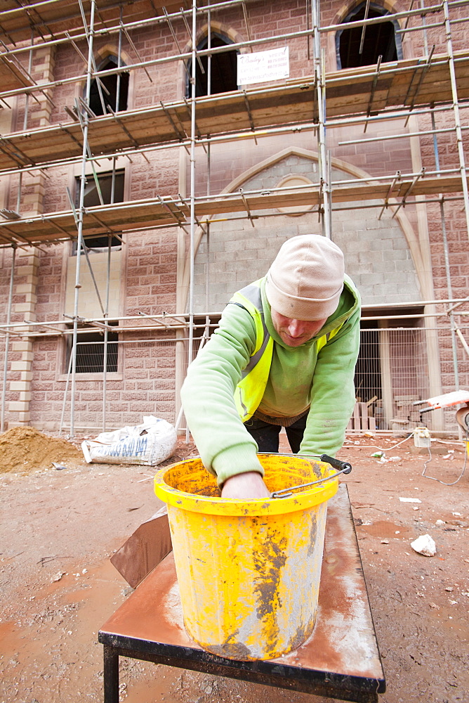 A builder working on a new mosque being built in Keighley, West Yorkshire, Yorkshire, England, United Kingdom, Europe